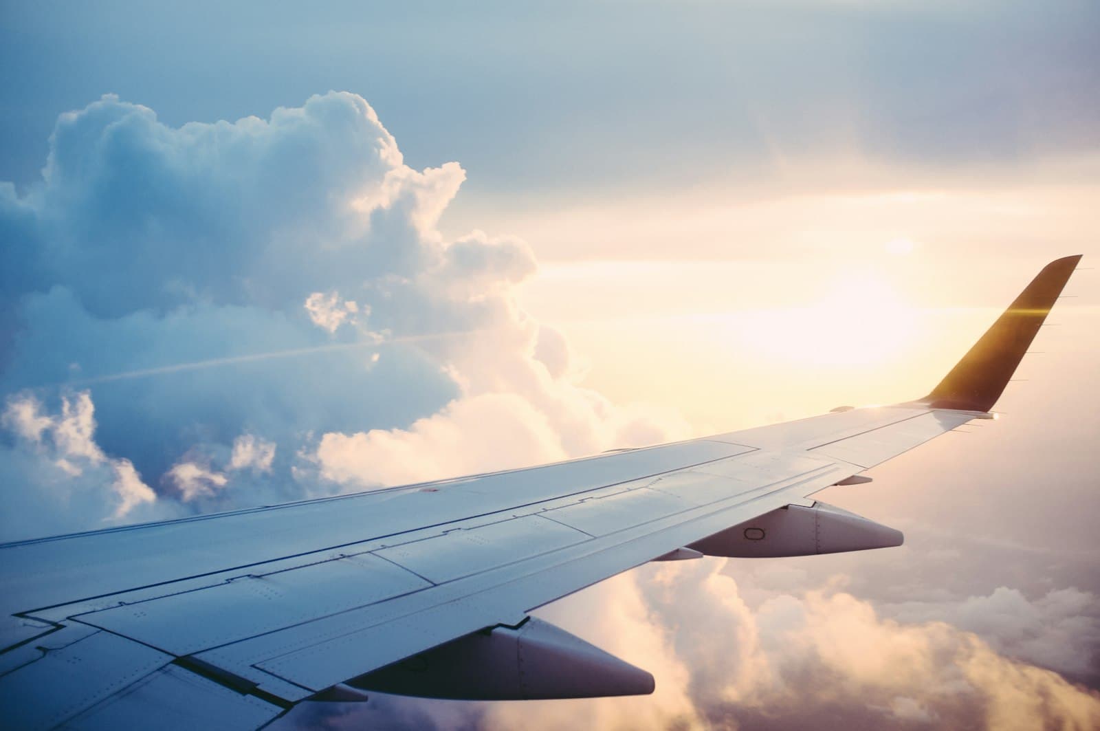 Passenger airliner taking off into golden sunset sky background